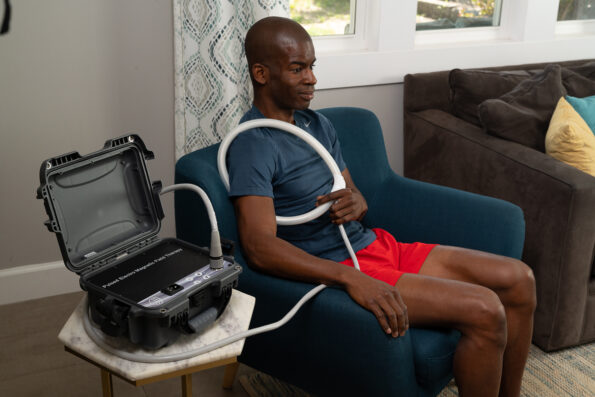 Man applies Loop applicator from TeslaFit Plus 2 Portable around his shoulder