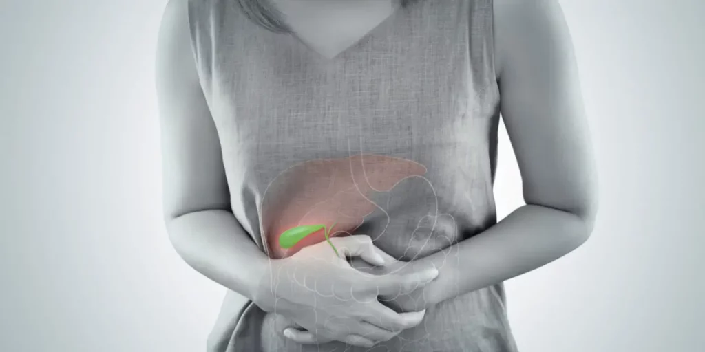 Women holding her stomach in pain due to gallbladder disorders
