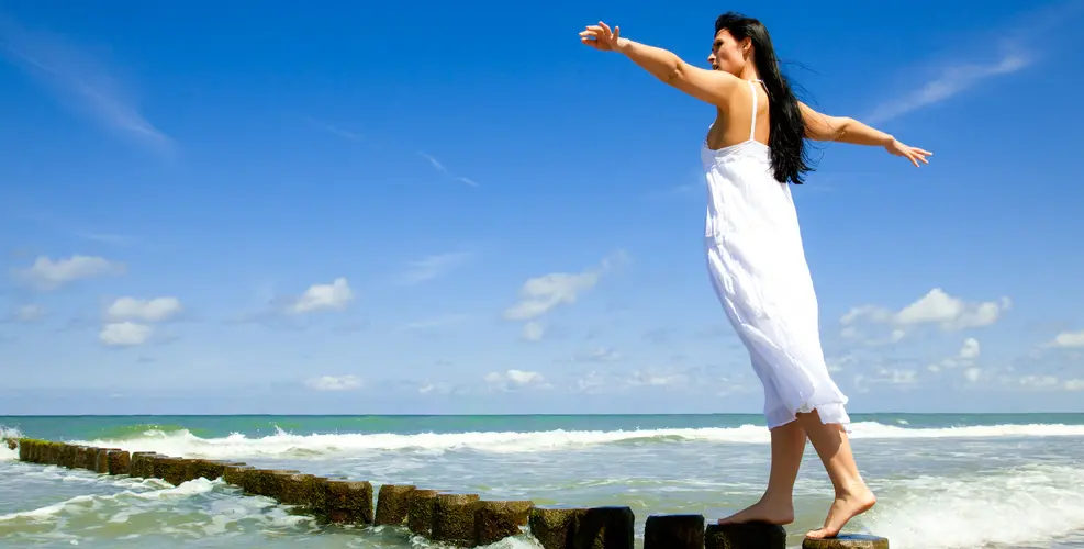 Women walking on rocks at the beach