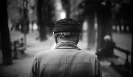 Older man walking down street with Alzheimer's Disease