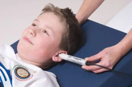 Child getting a probe stuck into his ear with the Medithera PEMF System